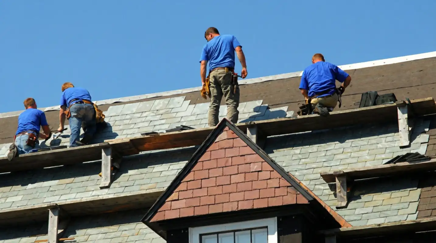 Roof replacement in progress with a team of professional contractors installing new shingles on a residential home in Staten Island, NY