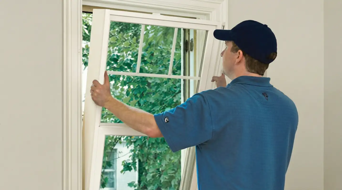 Professional contractors performing a residential window insulation and replacement service in Staten Island, NY